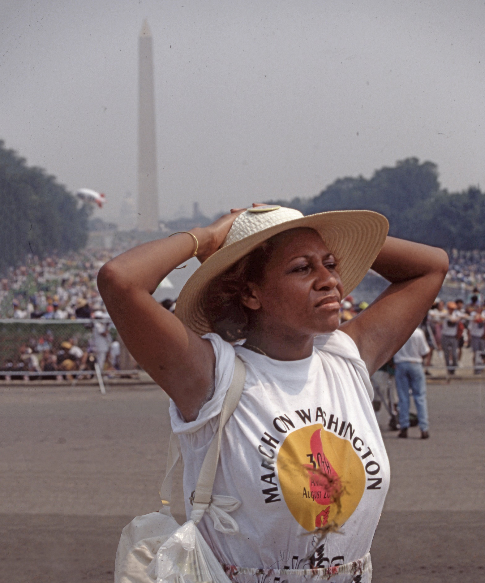 A person wearing a hat and holding her hands behind her head

Description automatically generated with low confidence