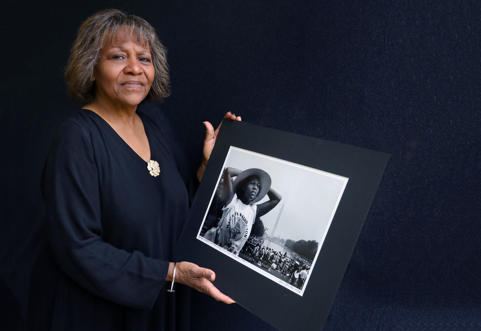 Medium shot of a person holding a picture

Description automatically generated